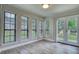 Bright dining room features a set of glass patio doors near four large windows with a backyard view at 924 Park Gate Pl, Stone Mountain, GA 30083