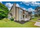 A charming tan two-story home with a spacious lawn and a covered porch at 924 Park Gate Pl, Stone Mountain, GA 30083