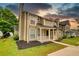 Exterior of townhome featuring a quaint porch, stone accents, and neutral siding at 924 Park Gate Pl, Stone Mountain, GA 30083