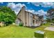 Well-manicured lawn and neutral siding exterior with charming porch, showcasing landscape at 924 Park Gate Pl, Stone Mountain, GA 30083