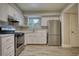 Modern kitchen with white cabinets, stainless steel appliances, granite countertops and gray backsplash at 924 Park Gate Pl, Stone Mountain, GA 30083
