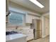 Modern kitchen with white cabinets, stainless steel appliances, granite countertops and gray backsplash at 924 Park Gate Pl, Stone Mountain, GA 30083