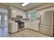 Modern kitchen with white cabinets, stainless steel appliances, granite countertops and gray backsplash at 924 Park Gate Pl, Stone Mountain, GA 30083