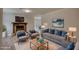 A spacious living room with a stone fireplace, grey sofa, and decoratively matched blue pillows at 924 Park Gate Pl, Stone Mountain, GA 30083