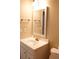 Clean bathroom with a white vanity, framed mirror, and gold hardware at 1245 Mclendon Dr, Decatur, GA 30033