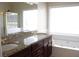 Bright bathroom featuring a soaking tub, granite countertop, and separate shower at 1245 Mclendon Dr, Decatur, GA 30033