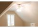 Bedroom with vaulted ceiling, ceiling fan, and window with shutters at 1245 Mclendon Dr, Decatur, GA 30033