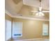 A bedroom with a tray ceiling, ceiling fan, and two windows with white blinds at 1245 Mclendon Dr, Decatur, GA 30033
