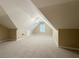 Spacious bonus room with carpet, ceiling fan, and natural light at 1245 Mclendon Dr, Decatur, GA 30033