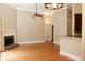Open-concept living area with hardwood floors, fireplace, and connection to the kitchen at 1245 Mclendon Dr, Decatur, GA 30033