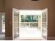 Open french doors leading to a spacious outdoor deck with natural light at 1245 Mclendon Dr, Decatur, GA 30033