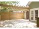 View of wooden patio with pergola and privacy screen, as well as entry door to the home at 1245 Mclendon Dr, Decatur, GA 30033