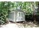 Storage shed in a backyard shaded by mature trees at 1245 Mclendon Dr, Decatur, GA 30033