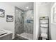 Bathroom featuring tiled shower, sleek toilet, and stylish storage shelf at 2160 Perkerson Sw Rd, Atlanta, GA 30315