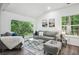 Bright living room featuring large windows with backyard views, comfortable seating, and contemporary decor at 2160 Perkerson Sw Rd, Atlanta, GA 30315