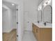 Bathroom featuring double vanity, stylish mirrors, modern fixtures, and a view of the walk-in closet at 2601 Garland Way, Duluth, GA 30096