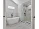 Spa-like bathroom with a soaking tub, glass enclosed shower, and marble accents at 2601 Garland Way, Duluth, GA 30096