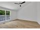 Bright bedroom with a large window offering an outdoor view and wood-look flooring at 2601 Garland Way, Duluth, GA 30096