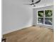 Bright bedroom with a large window offering an outdoor view and wood-look flooring at 2601 Garland Way, Duluth, GA 30096
