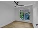 Bedroom features hardwood floors, a ceiling fan, and a bright window at 2601 Garland Way, Duluth, GA 30096