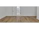 Bright bedroom featuring modern wood-look floors and a door leading to the bathroom at 2601 Garland Way, Duluth, GA 30096