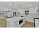 Beautiful kitchen featuring white cabinets, a center island with a microwave, and bar stool seating at 2601 Garland Way, Duluth, GA 30096
