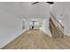 Open living room featuring hardwood floors and sightlines into the kitchen and dining areas at 2601 Garland Way, Duluth, GA 30096