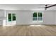Bright living room boasts hardwood floors, recessed lighting, a ceiling fan, and sliding glass doors to the backyard at 2601 Garland Way, Duluth, GA 30096