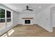 Bright living room features hardwood floors, a window, and a fireplace with an attractive wood mantle at 2601 Garland Way, Duluth, GA 30096