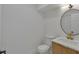 Contemporary powder room with wood vanity, marble countertop, brass faucet, and round mirror at 2601 Garland Way, Duluth, GA 30096