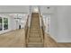 View of staircase with wood treads and black metal railings, and adjacent views to kitchen and living area at 2601 Garland Way, Duluth, GA 30096