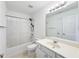 Bright bathroom featuring a shower-tub combo with curtain and a white single sink vanity at 2642 Colleen Ln, Dacula, GA 30019