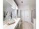 Bathroom with long vanity, double sinks, a glass shower, and multiple doors at 2642 Colleen Ln, Dacula, GA 30019