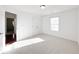 This bedroom has neutral carpeting and a large closet with light from the window at 2642 Colleen Ln, Dacula, GA 30019