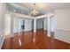 Dining area with hardwood floors, decorative columns, and a chandelier, open to the kitchen at 2642 Colleen Ln, Dacula, GA 30019