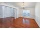 Elegant dining room featuring hardwood floors, wainscoting, a modern chandelier, and abundant natural light at 2642 Colleen Ln, Dacula, GA 30019