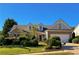 Charming home featuring a stone-accented facade, manicured landscaping, and a welcoming two-car garage at 2642 Colleen Ln, Dacula, GA 30019