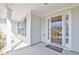 Inviting covered front porch with white columns, neutral siding, and a glass-paneled front door at 2642 Colleen Ln, Dacula, GA 30019