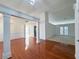 Open-concept living area showcasing hardwood floors, stylish columns, and seamless flow into other living spaces at 2642 Colleen Ln, Dacula, GA 30019