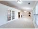 Open-concept living room boasts plush carpeting and abundant natural light at 2642 Colleen Ln, Dacula, GA 30019