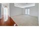 Open room featuring carpet flooring, ample space, and natural light from double doors at 2642 Colleen Ln, Dacula, GA 30019