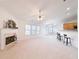 Spacious living room featuring carpet, a fireplace, and an open layout with a bar area at 2642 Colleen Ln, Dacula, GA 30019