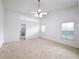 Spacious main bedroom with a ceiling fan, carpet, and abundant natural light at 2642 Colleen Ln, Dacula, GA 30019