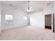 Spacious main bedroom with carpet, natural lighting, and ceiling fan at 2642 Colleen Ln, Dacula, GA 30019