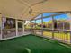 Relax on this home's screened-in porch, featuring a ceiling fan and peaceful views of the backyard at 2642 Colleen Ln, Dacula, GA 30019