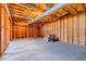 Unfinished basement showcasing wooden beams and concrete floors, offering customizable space and storage at 4348 Tillage Path, Douglasville, GA 30135
