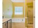 This secondary bathroom has a large tub and a shower at 4348 Tillage Path, Douglasville, GA 30135