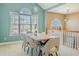 Bright dining room featuring a wood table, neutral walls, and a large window with an arch above it at 4348 Tillage Path, Douglasville, GA 30135