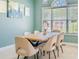 Bright dining room featuring a wood table and six chairs next to a large window with an arch above it at 4348 Tillage Path, Douglasville, GA 30135