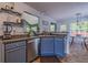 Kitchen with granite countertops, stainless appliances, gray cabinets, and view into eat-in kitchen area at 4348 Tillage Path, Douglasville, GA 30135